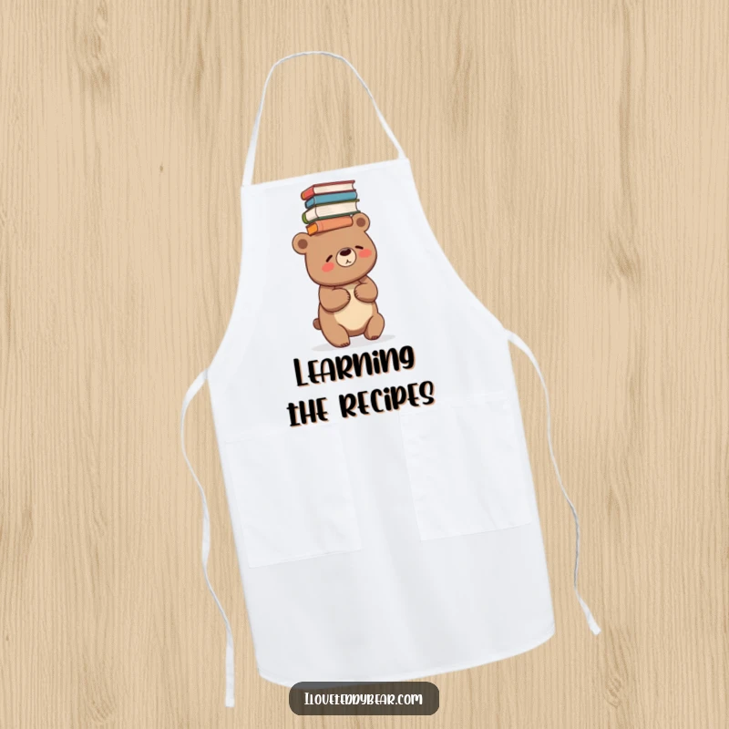 Funny apron showing a bear giggling while balancing a stack of books on its head, perfect for readers.