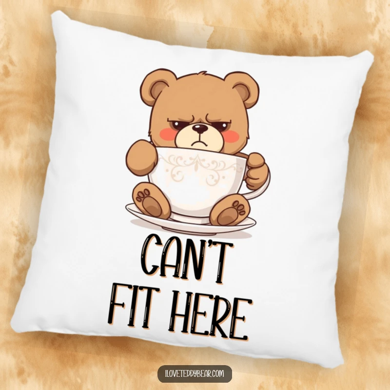 Funny pillow with a grumpy teddy bear comically attempting to fit into a tiny teacup, conveying a humorous struggle. Excellent funny gift.