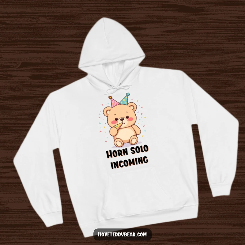 Funny Hoodie: A plump teddy bear in a festive party hat joyfully blows a confetti horn, radiating infectious celebratory spirit and playful charm.