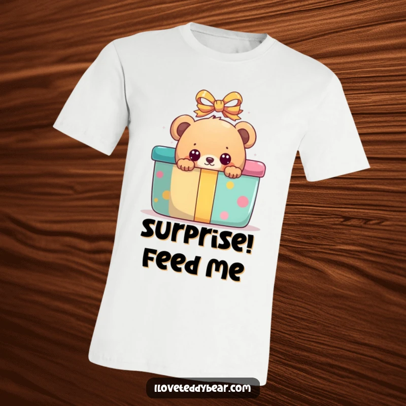 Funny t-shirt graphic of a bear peeking with wide, curious eyes from behind a large, brightly colored present.